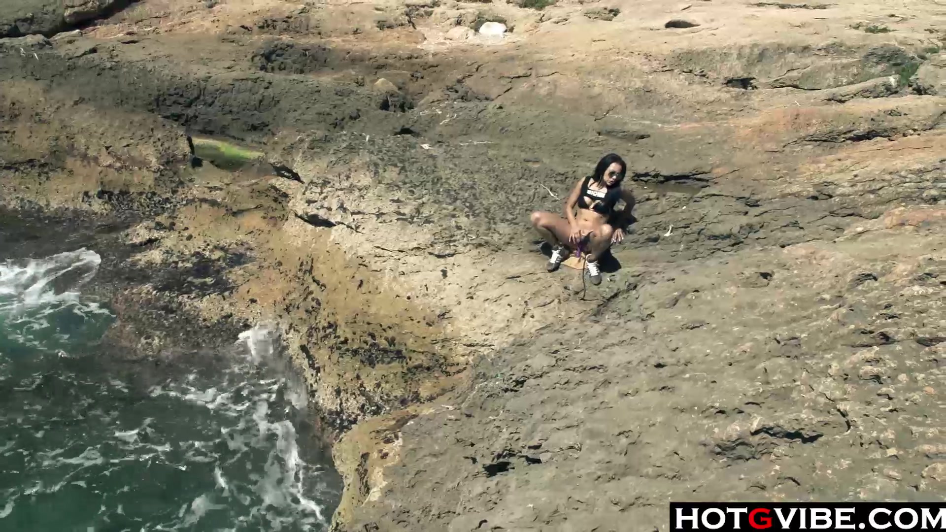 Slim Spanish Latina fucks herself on the beach