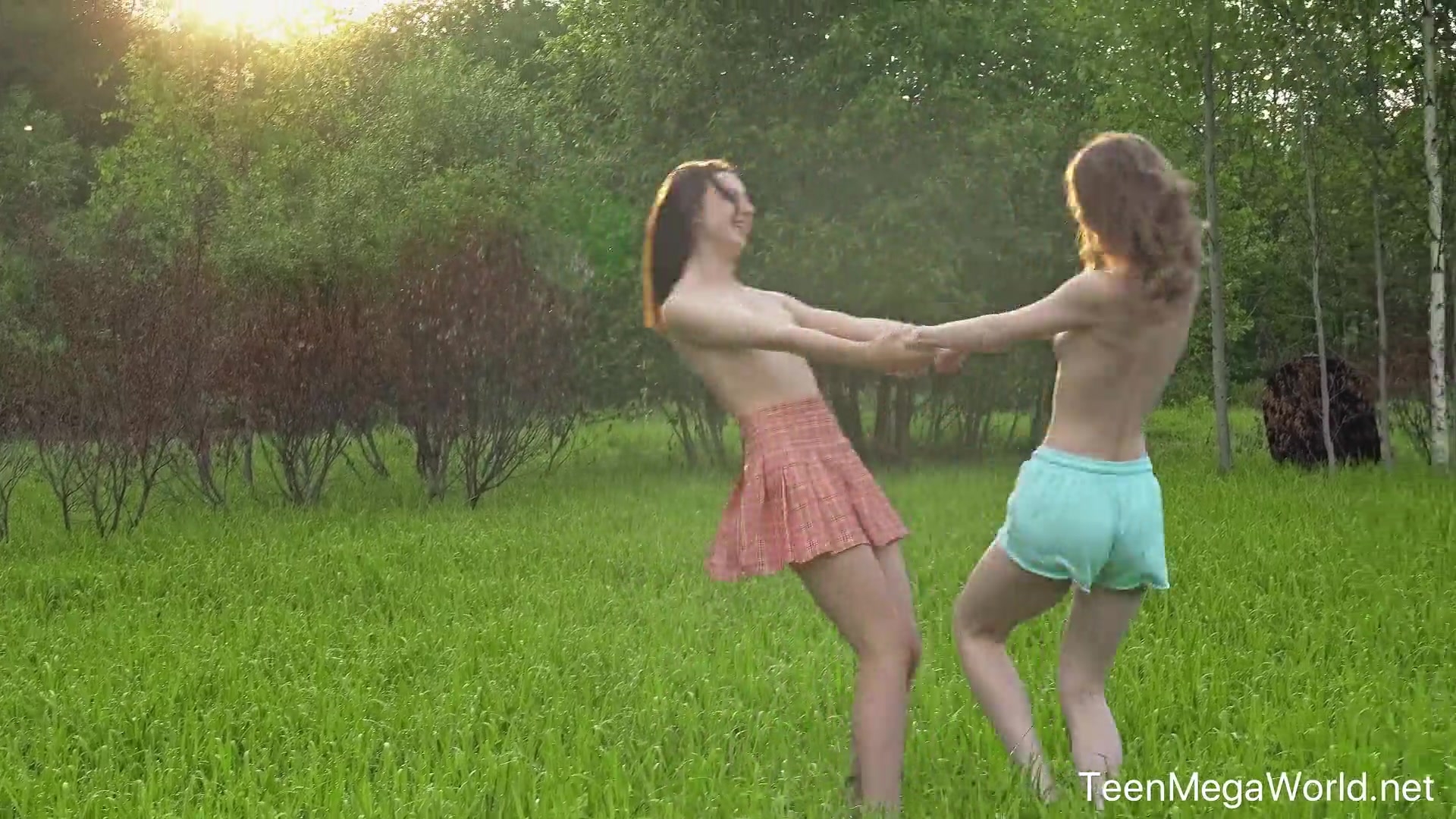 Hot chicks lick clits in field