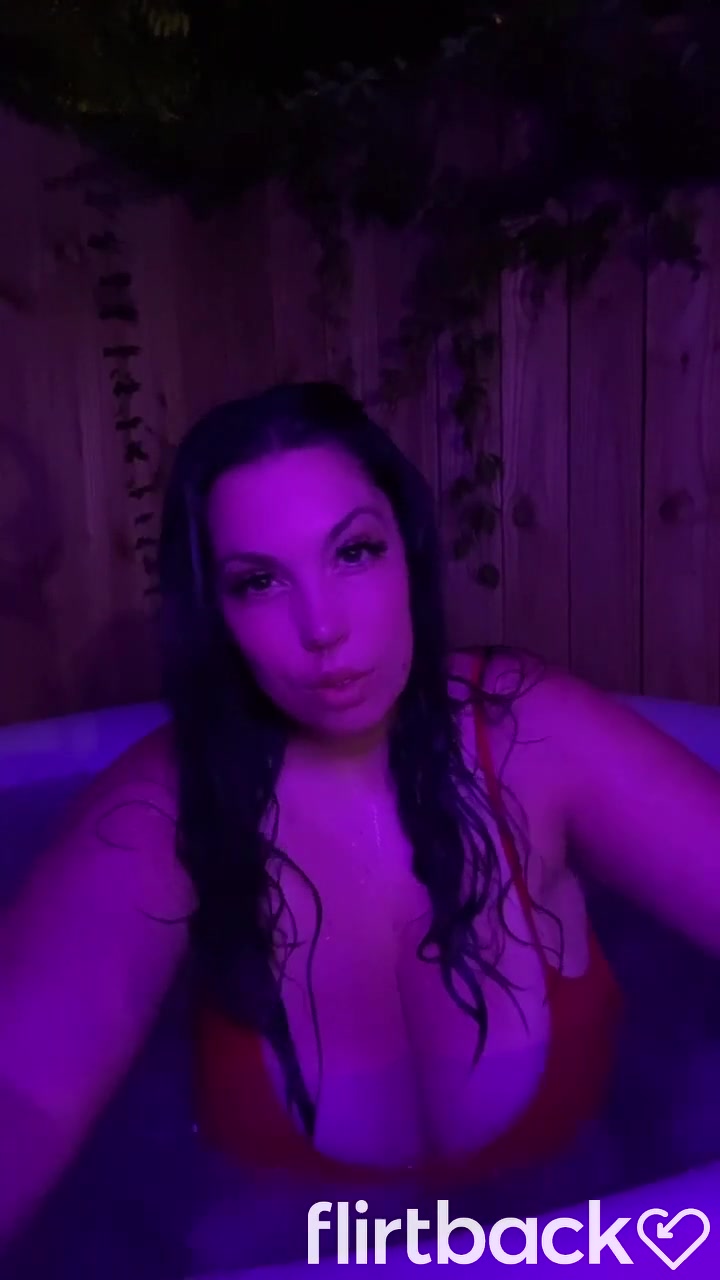 Brunnette flashing her boobs at the hot tub