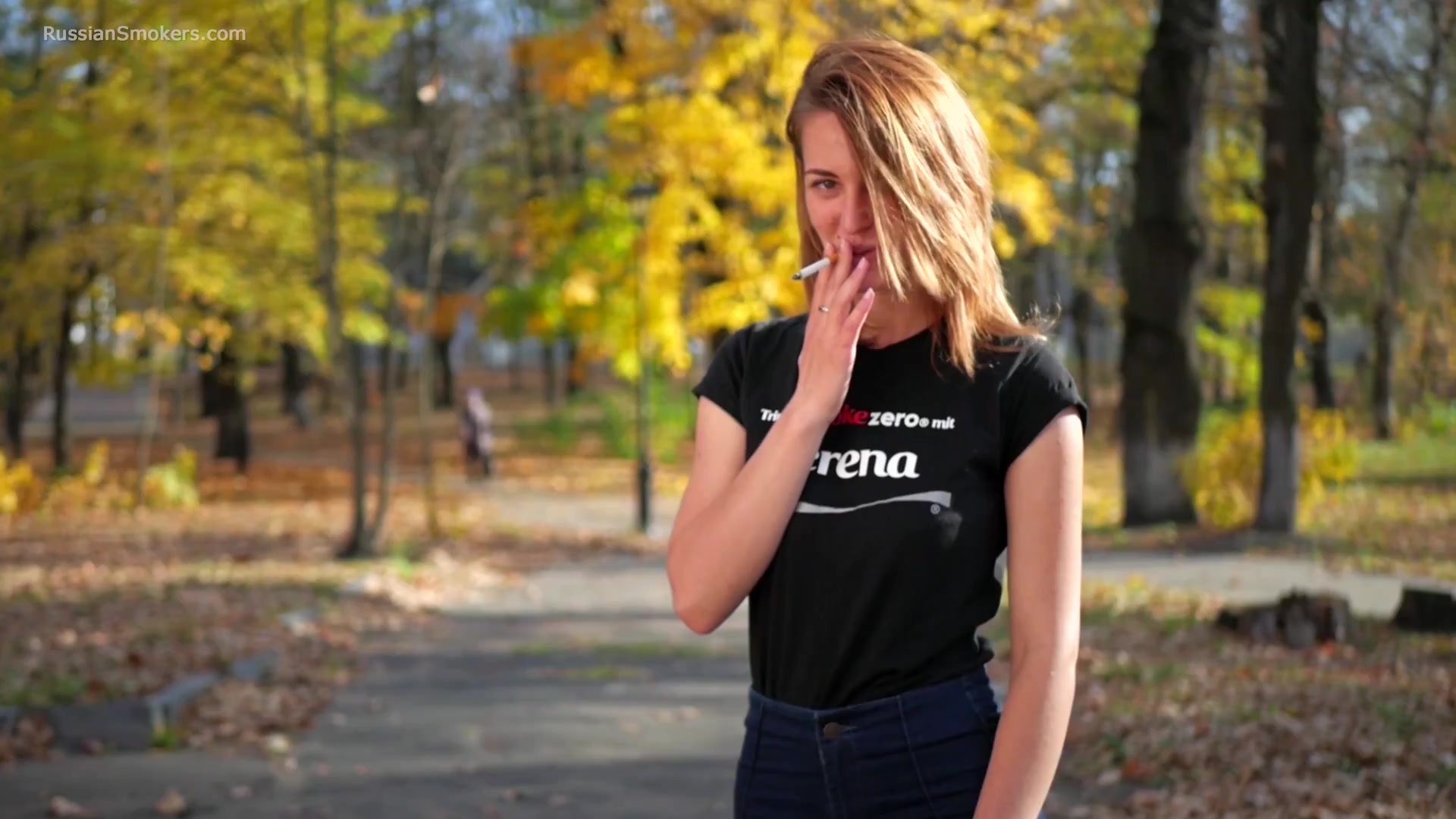 Sasha Is Smoking Two Cigarettes One By One In The Autumn Park
