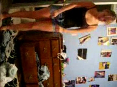 Blonde young girl taking her clothes off slowly