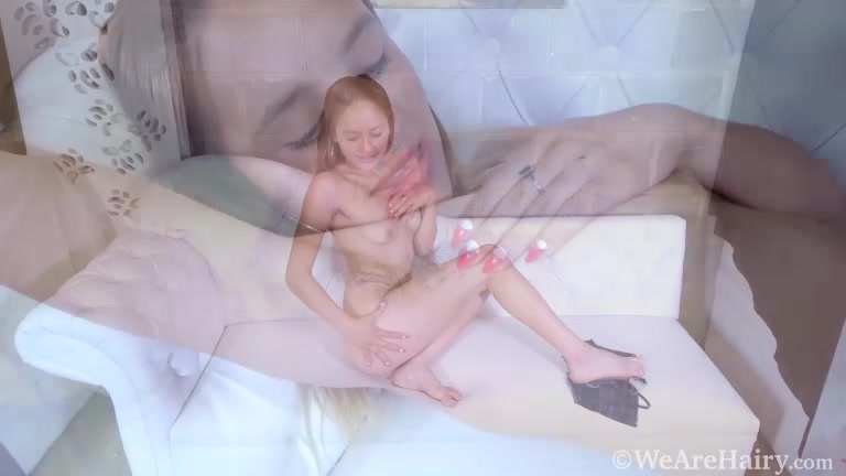 Clarita masturbates with her toy on a white couch - WeAreHairy