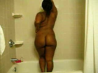 Ebony bitch with curves washes her brown twat in the shower