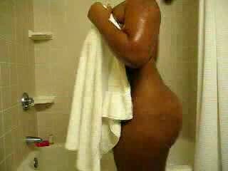 Ebony bitch with curves washes her brown twat in the shower