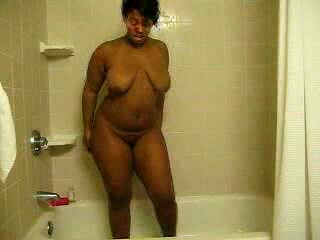Ebony bitch with curves washes her brown twat in the shower