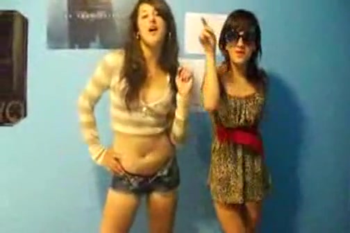 Stunning young brunettes dancing to music and stripping