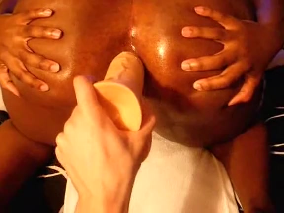 Ebony spreads her butt cheeks to be pierced anally by a sex toy