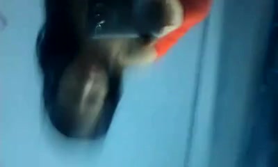 Asian slut films her naked boobies in the mirror