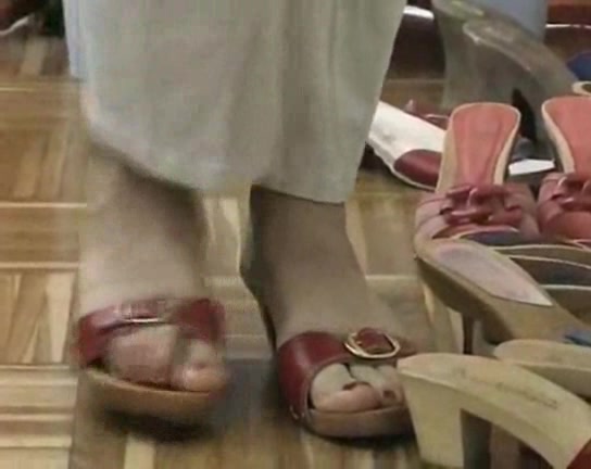 Lovely woman trys on different shoes in the foot fetish vid