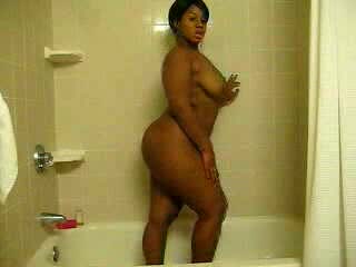 Ebony bitch with curves washes her brown twat in the shower
