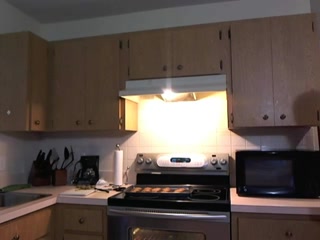 Sexy pig-tailed brunette being a horny girl in the kitchen