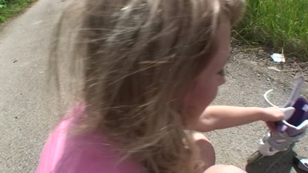 Gal on roller skates engulf on the bike path