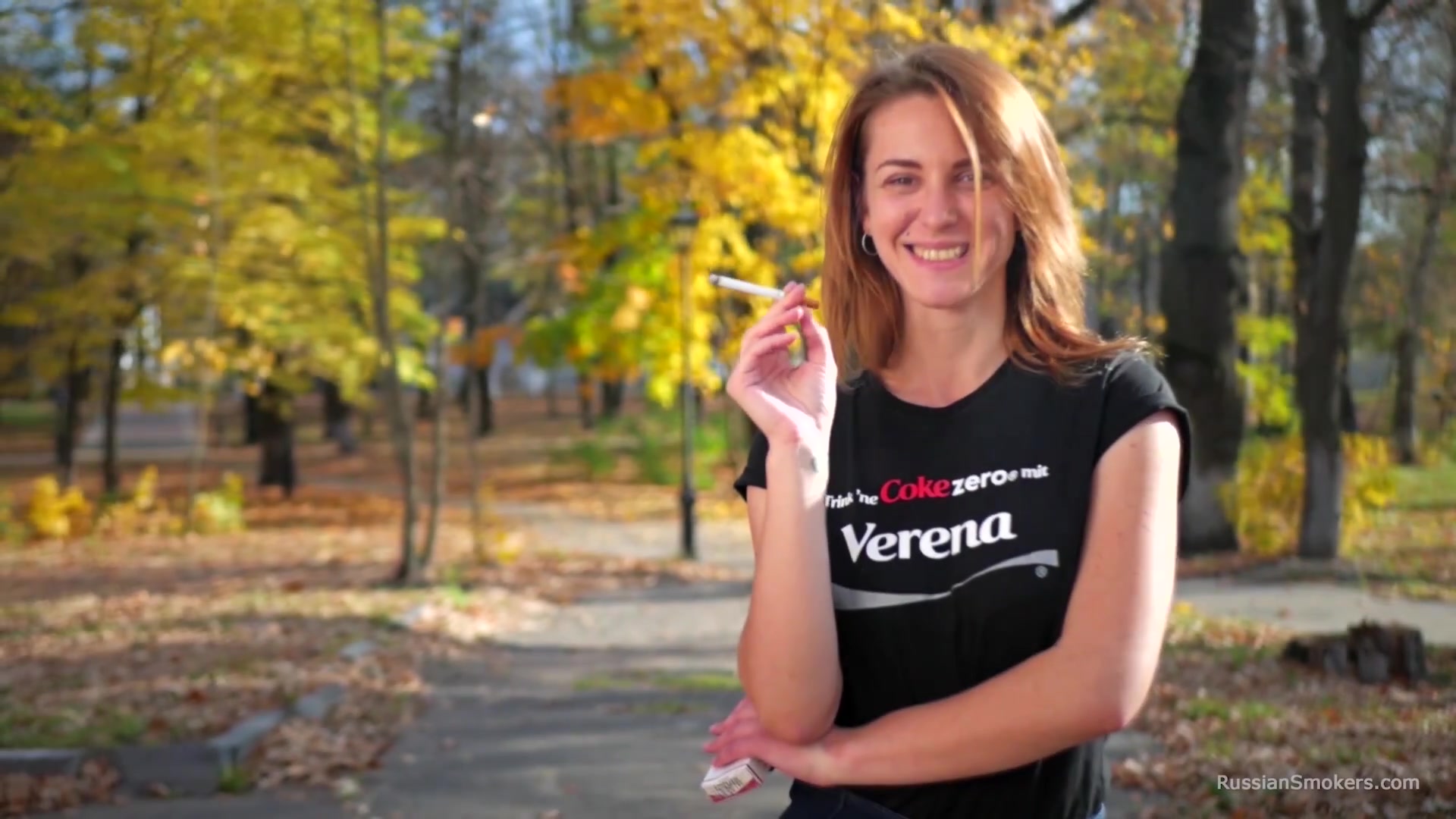 Sasha Is Smoking Two Cigarettes One By One In The Autumn Park