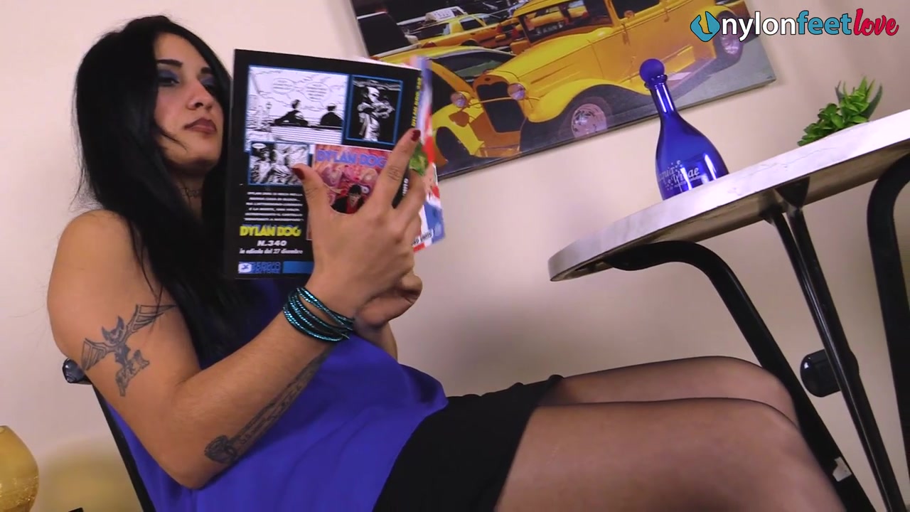 Sharon lets her black peep-toe platform pumps dangle off her nyloned feet
