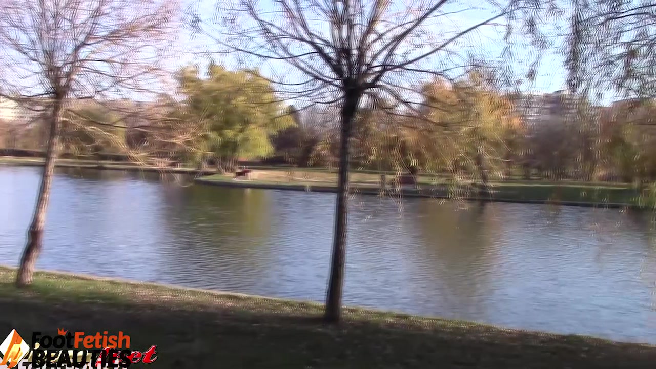 Barefoot brunette takes off nylons, shows feet in a park