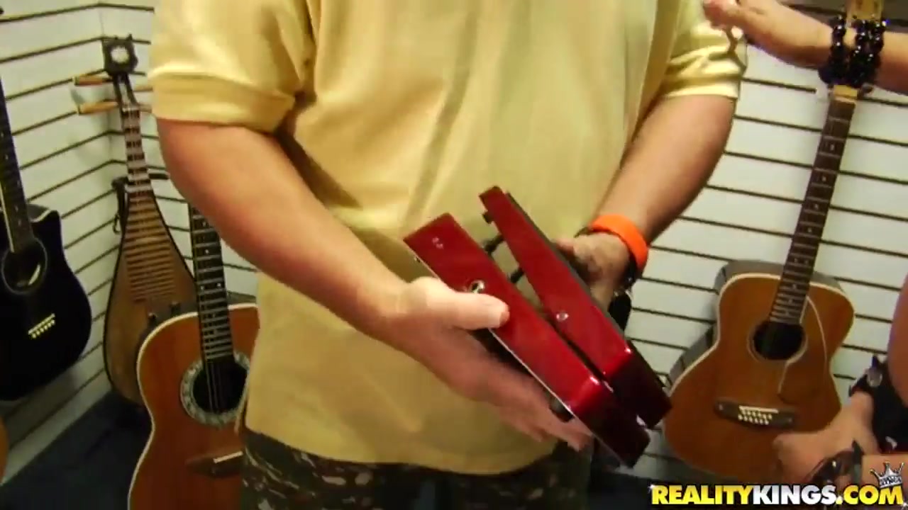 Dark haired chick is fucked in a musical shop