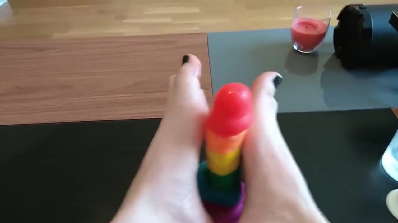 Femboy crossdresser gives rainbow dildo a footjob