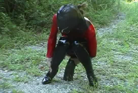 Butt toying in latex during a hike in the nature