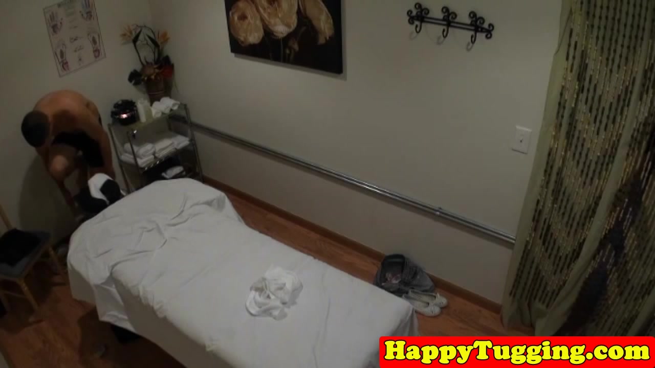 Asian masseuse jerking client on table