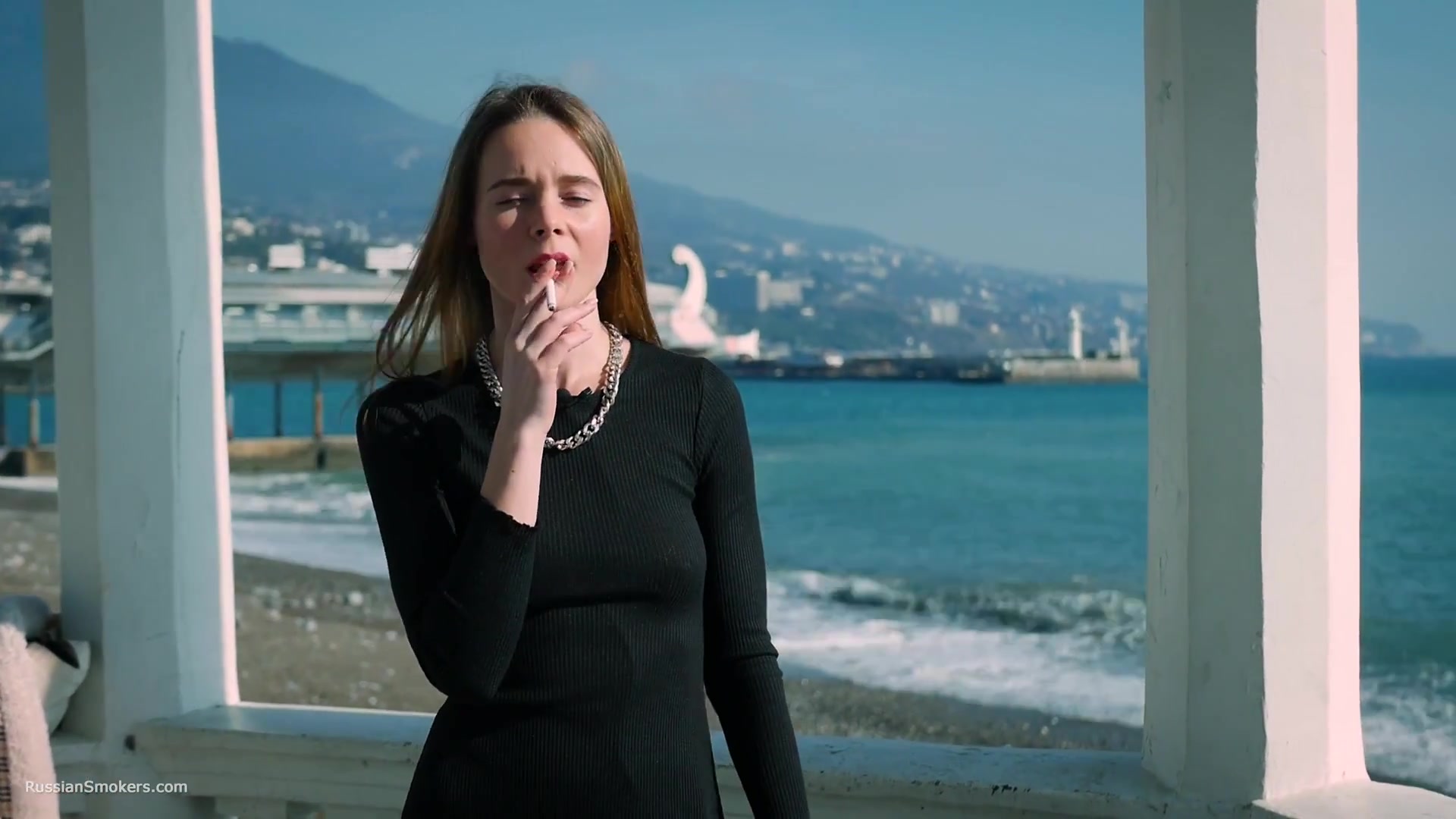 Slim Chick Basks In The Sun With A Cigarette In Her Hand