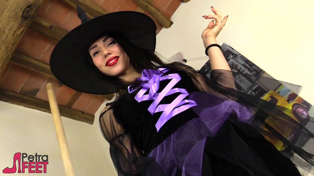 Stunning Petra dressed in a cosplay witch costume with black stockings.