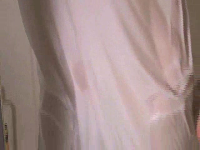 Skinny cute girl looks attractive in wet white T-skirt