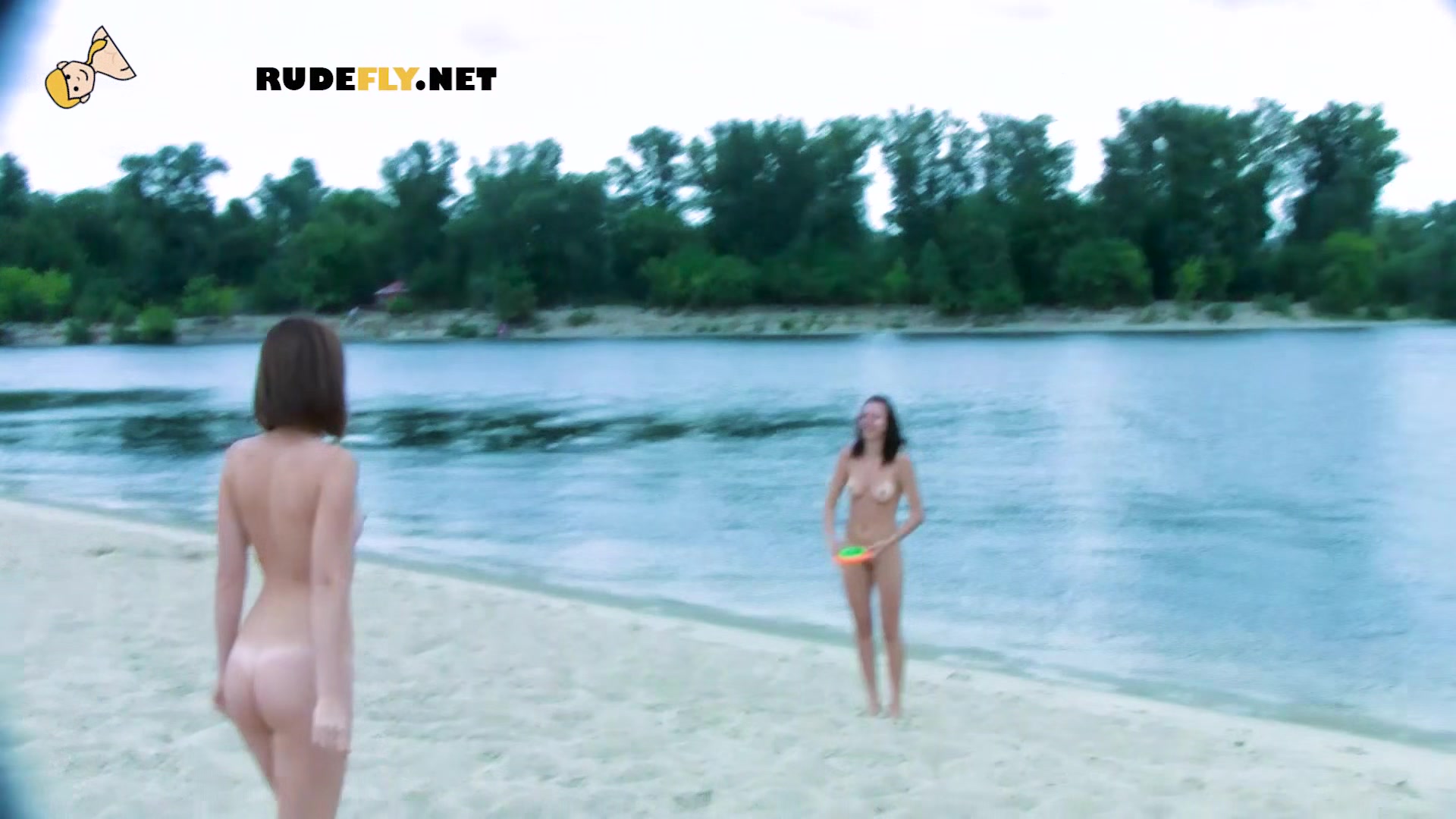 Nude beach girl is looking into the distance as her small tits and ass