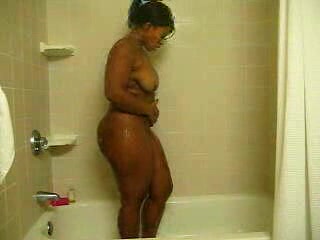 Ebony bitch with curves washes her brown twat in the shower