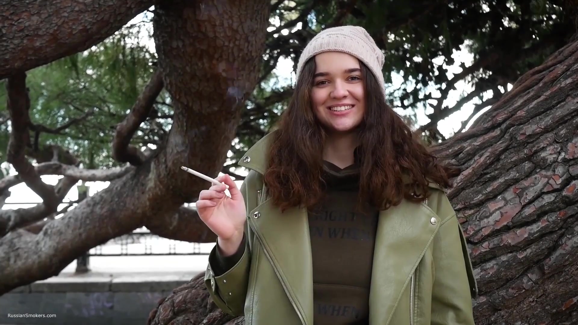 Young Brunette Is Taking An Unhurried Stroll With Allwhite 120mm Cigarette