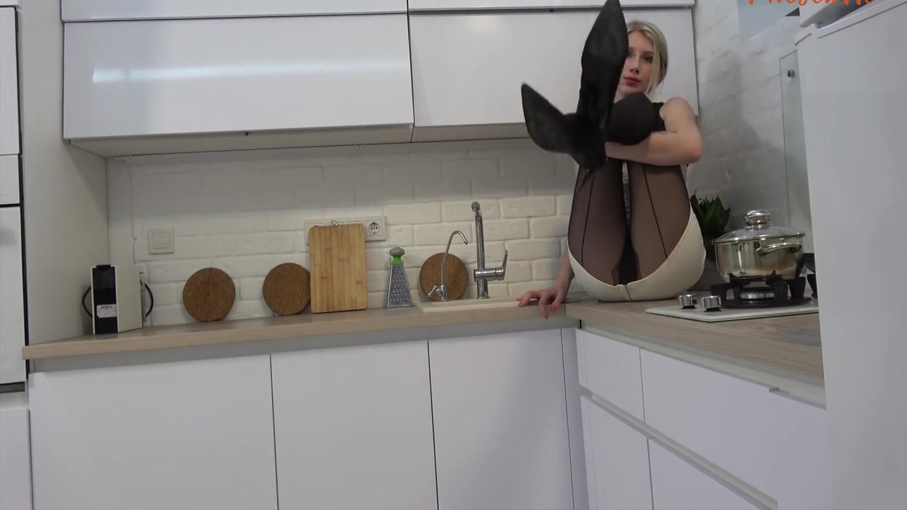 Hippie Blonde In The Kitchen Rubbing Her Pantyhosed Pussy