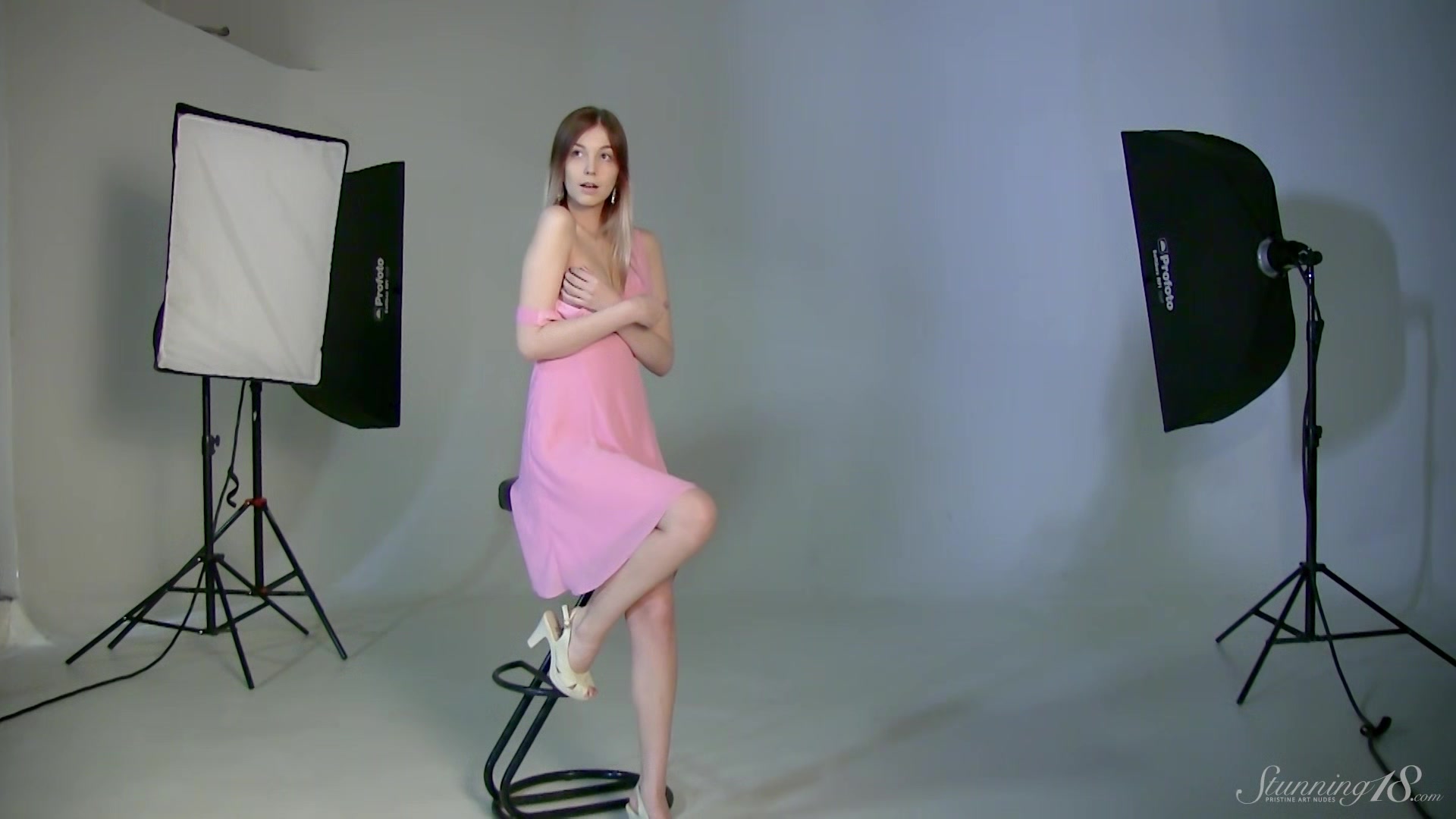 Brown Haired Nubile Model in a Cute Pink Dress Posing