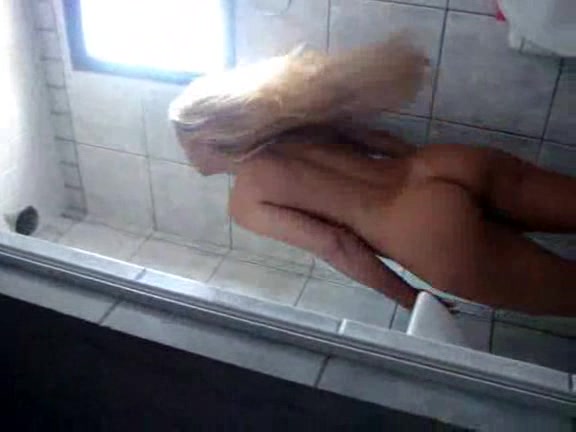Attractive blonde exposes her sexy body in the bathroom