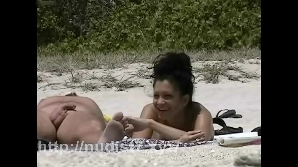 Beauty nudist putting sunscream on her mounds