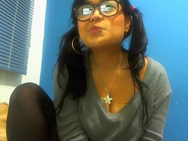 Pig-tailed adorable gal sucking a lollipop and showing her cleavage