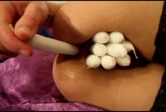 Masked floozy putting several sex toys in her pussy