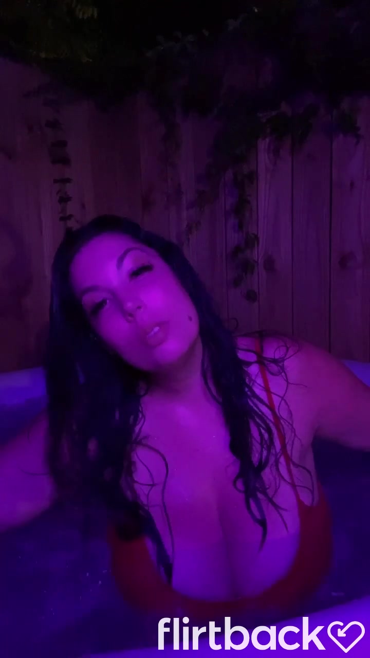 Brunnette flashing her boobs at the hot tub