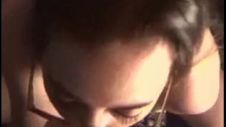 Sexy brunette in glasses knows how to suck a cock