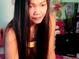 Cute Asian babe showing off her big boobs on camera