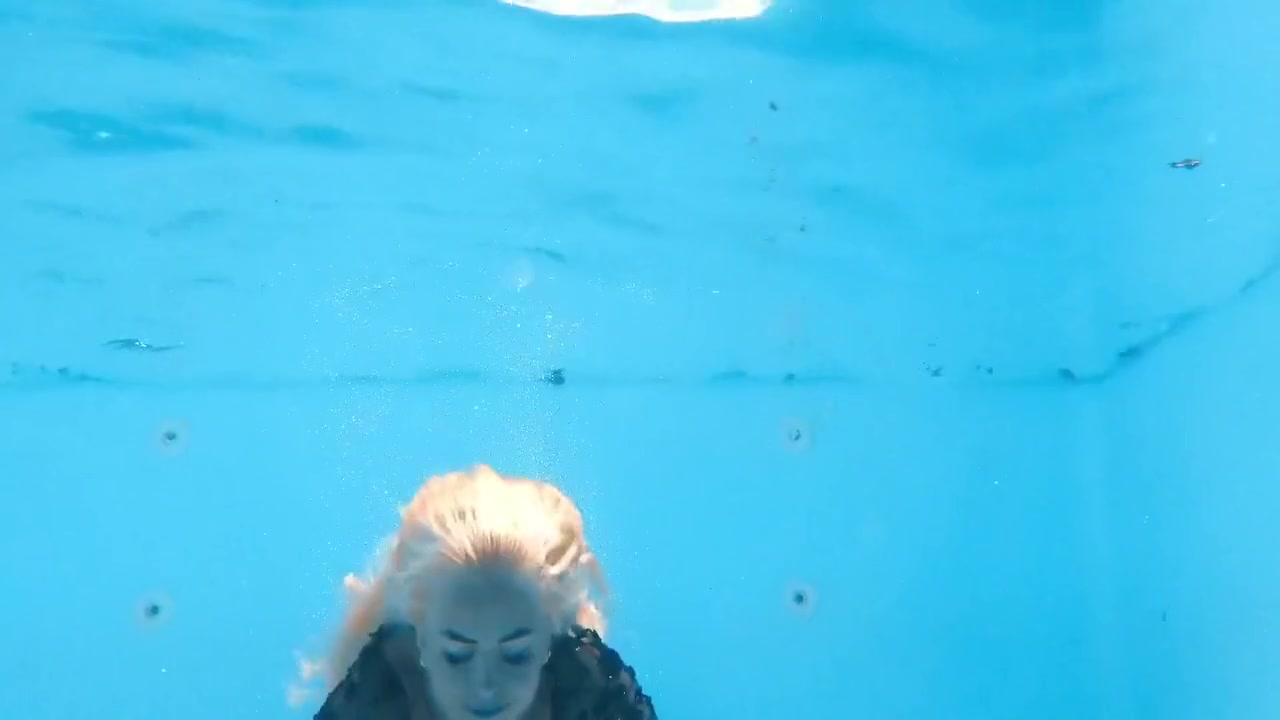 A Woman Floats In A Butterfly-adorned Mesh Dress