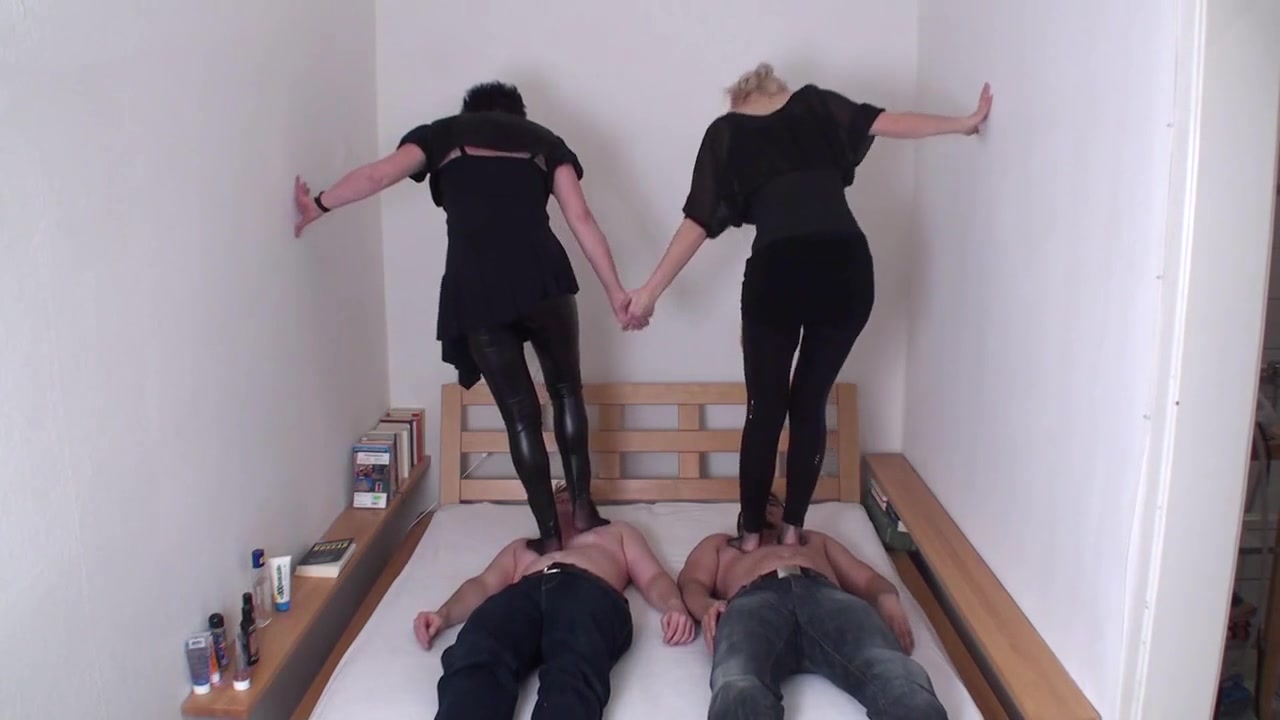Brunette and blonde are trampling on their slaves by Femdom Austria