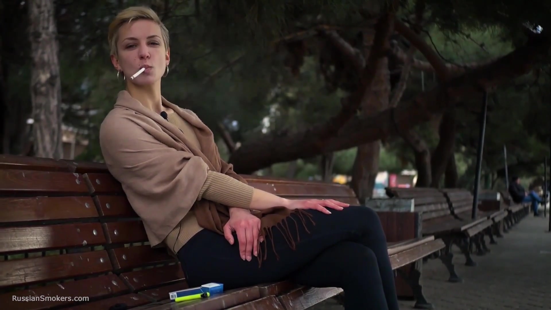 Short Cut Hair Blonde Girl Is Smoking All White 120mm Cigarettes
