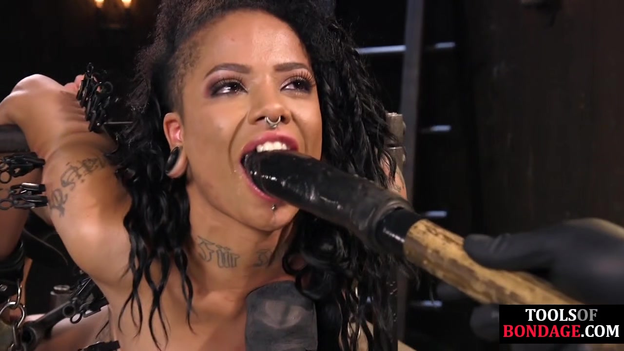 Bound black subject toyed with dildo during punishment