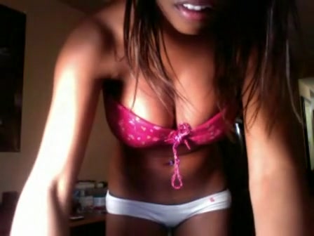 Chocolate-skinned boomshell in pink bra demonstrating her details