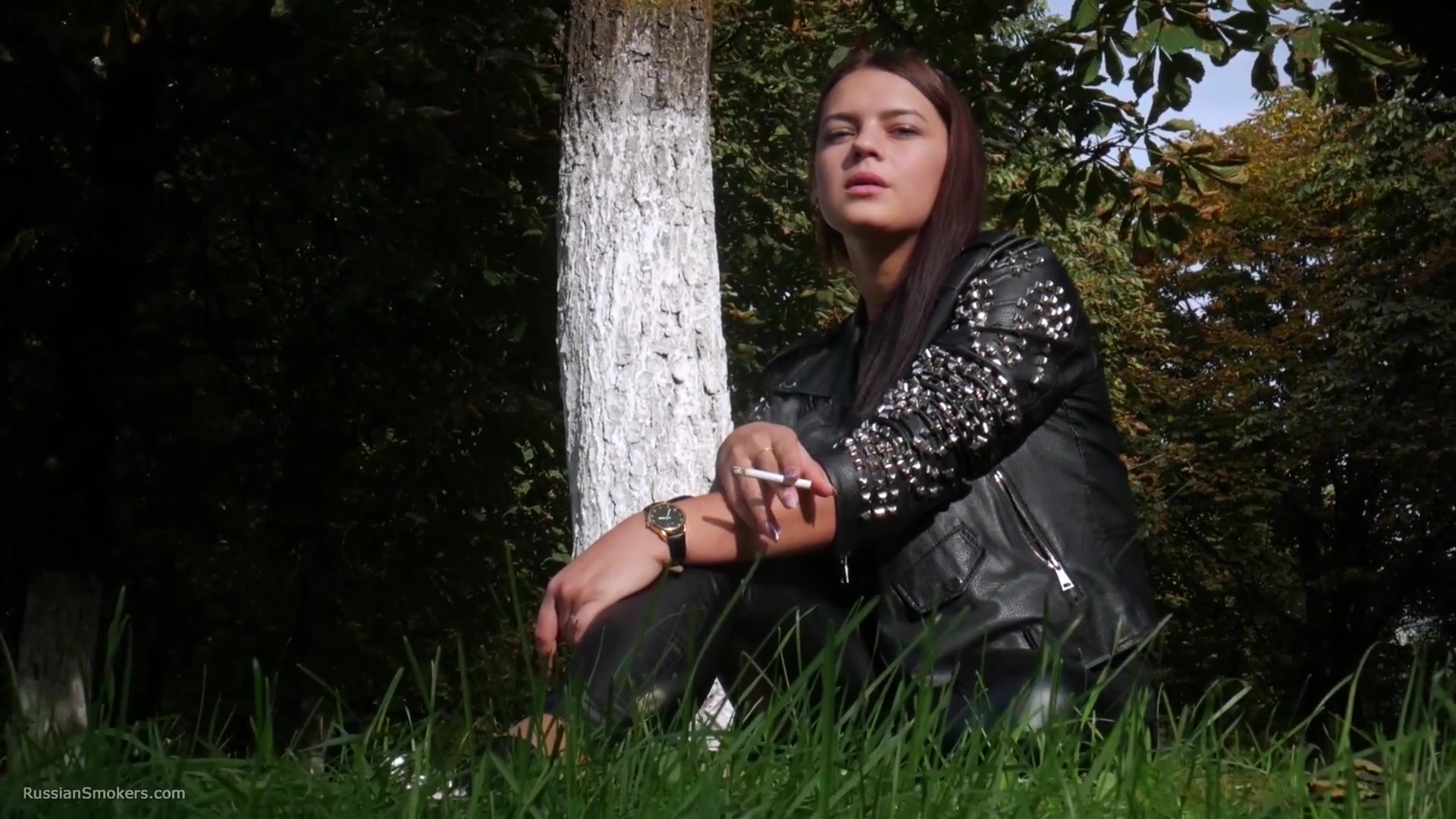Pretty Faced Asya Is Smoking A Cigarette Outdoors