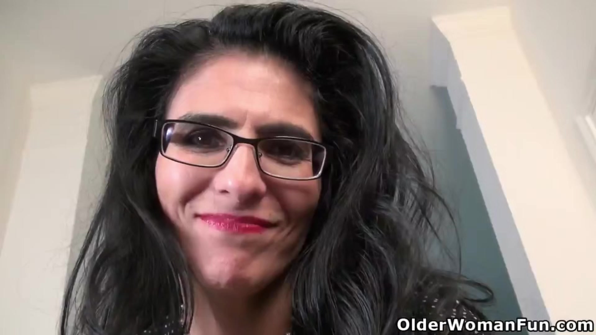 Mature Mimi uses massage oil on her nyloned pussy