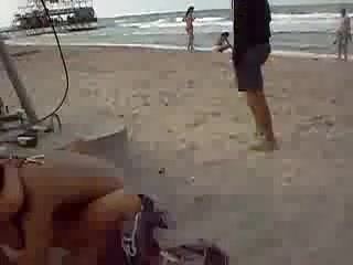 Naughty couple caught fucking on a public beach
