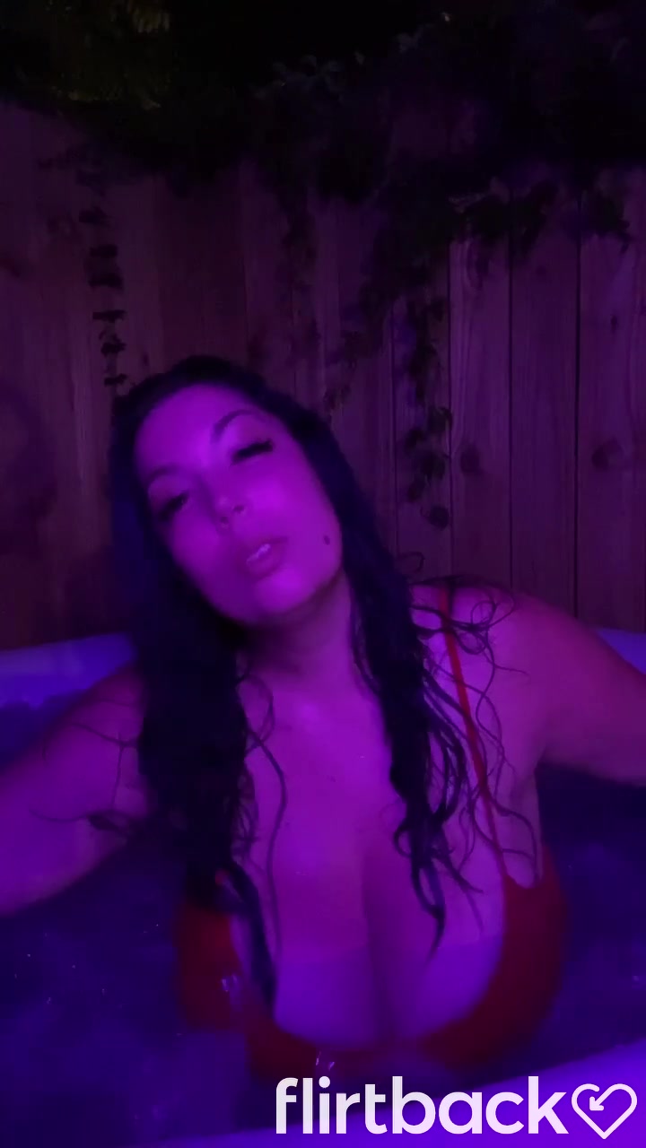 Brunnette flashing her boobs at the hot tub
