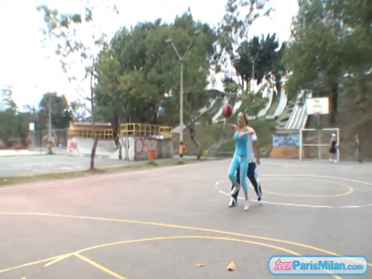 Paris Milan plays basketball outdoors
