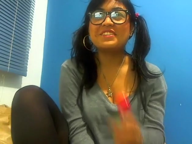 Pig-tailed adorable gal sucking a lollipop and showing her cleavage
