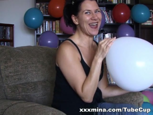 Brunette slut teasing while blowing balloons